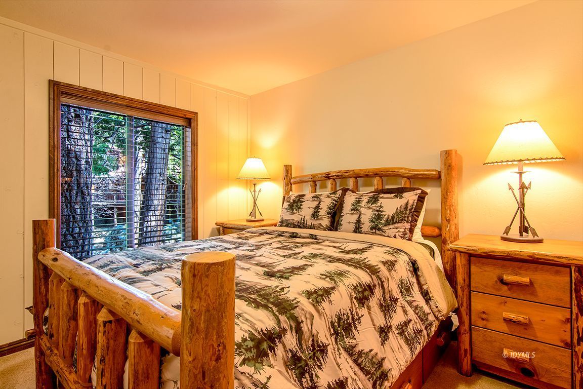 24750 Upper Rim Rock Road Idyllwild, CA 92549 - Photo 35 of 58 a bed sitting in a bedroom next to a window