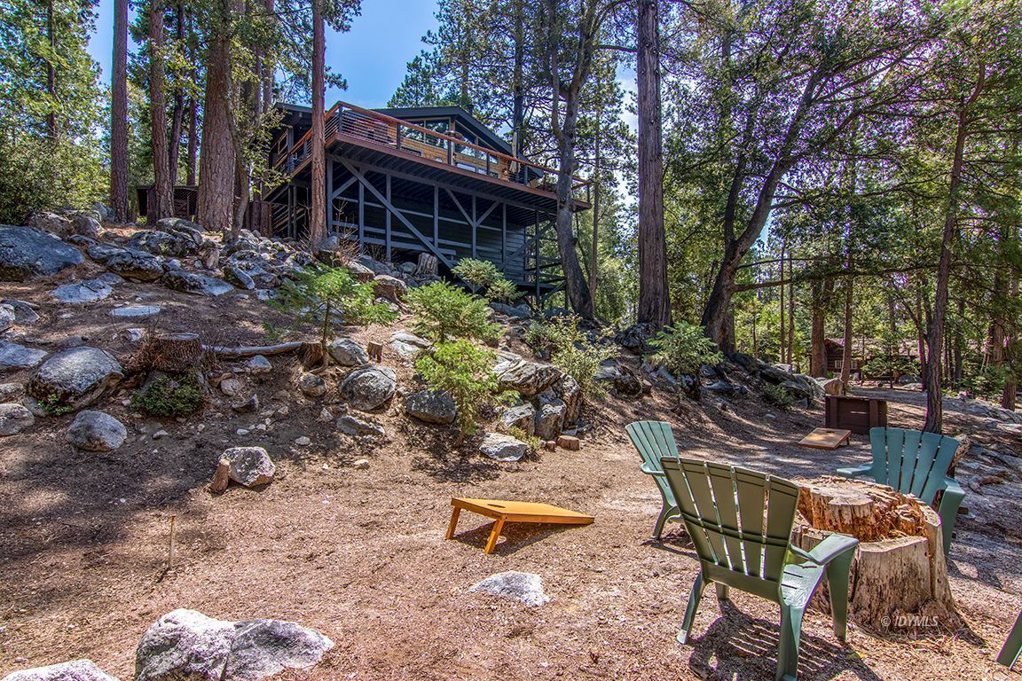24750 Upper Rim Rock Road Idyllwild, CA 92549 - Photo 50 of 58 a backyard of a house with table and chairs