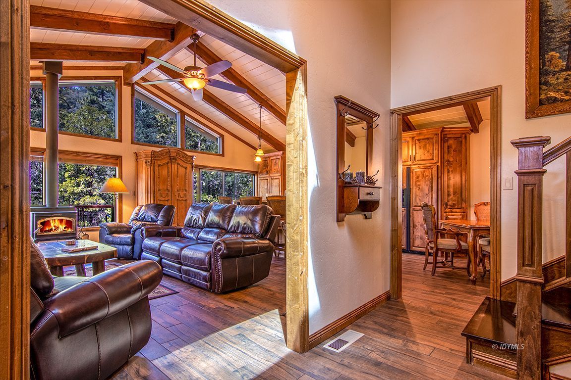 24750 Upper Rim Rock Road Idyllwild, CA 92549 - Photo 7 of 58 a living room with furniture a large window and wooden floor