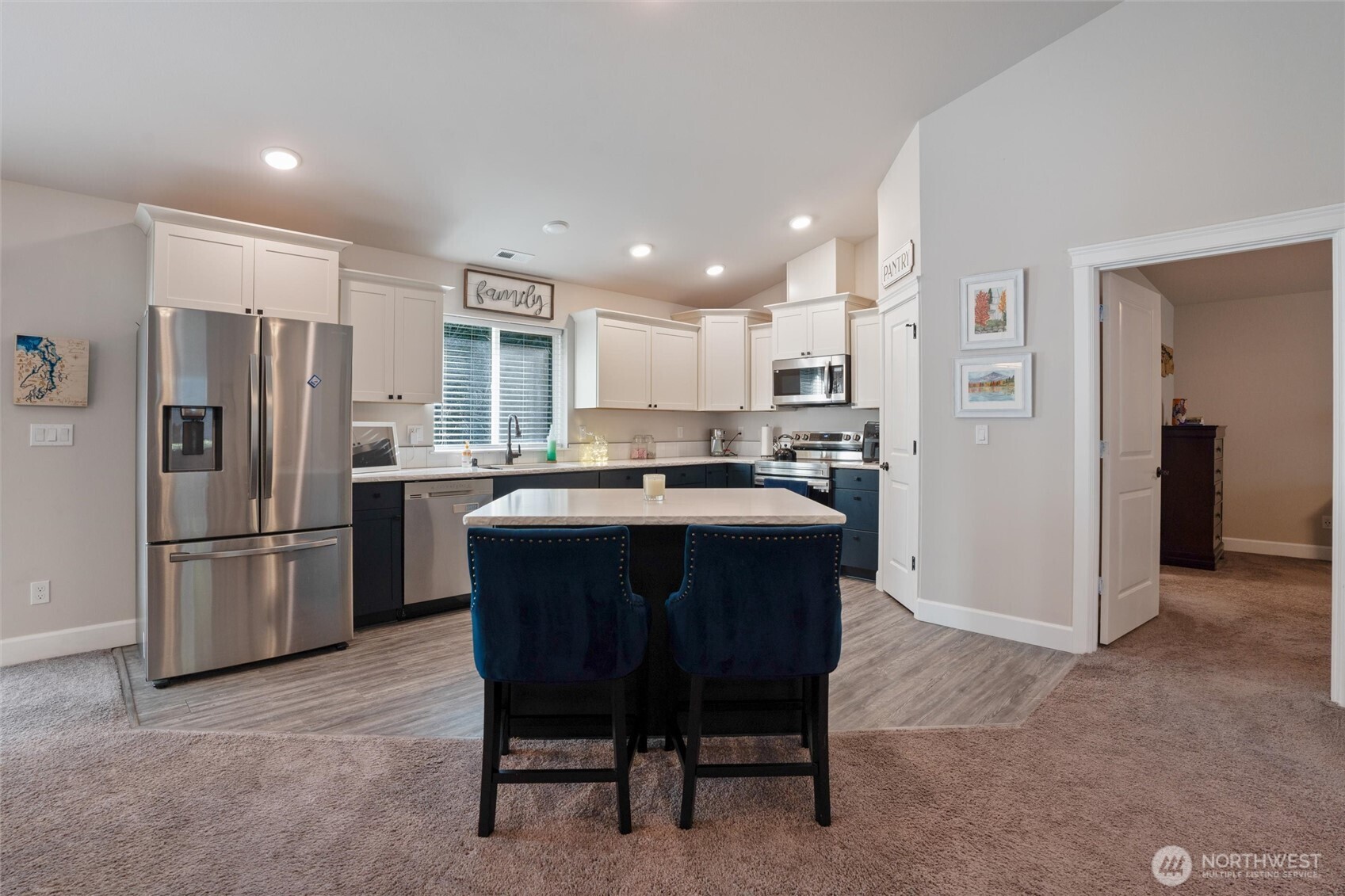 21356 Jefferson Beach Road Northeast Kingston, WA 98346 - Photo 12 of 40 a kitchen with refrigerator a sink and chairs