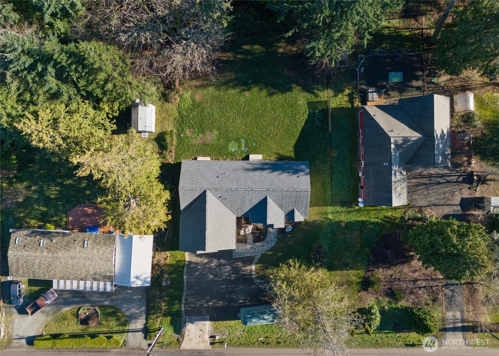 21356 Jefferson Beach Road Northeast Kingston, WA 98346 - Photo 35 of 40 an aerial view of a house with garden space and a car parked on the roadside