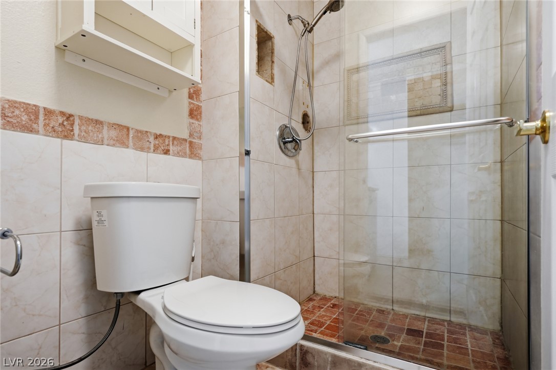 3971 Spring Leaf Drive Las Vegas, NV 89147 - Photo 20 of 48 Functional full bathroom featuring a glass-enclosed shower with a tiled surround.