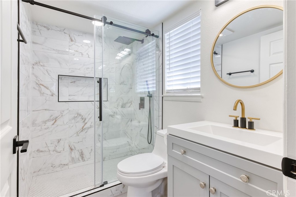 320 West Truslow Avenue, Unit D Fullerton, CA 92832 - Photo 11 of 25 a bathroom with a sink toilet and a mirror