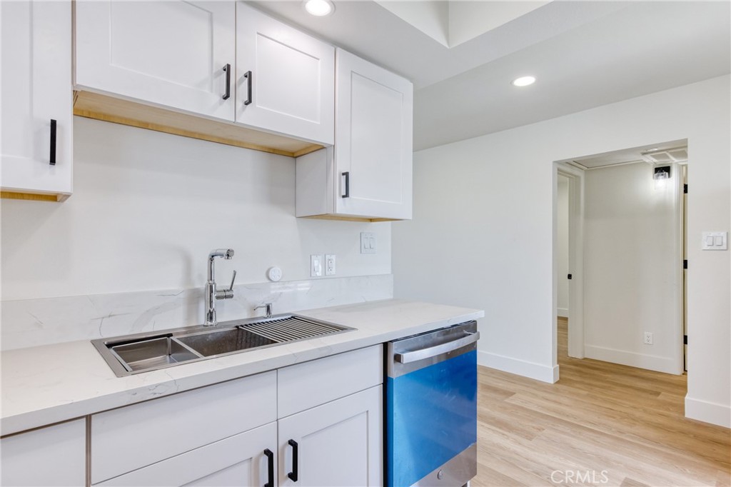 320 West Truslow Avenue, Unit D Fullerton, CA 92832 - Photo 16 of 25 a kitchen with stainless steel appliances granite countertop a sink a stove and a wooden cabinets