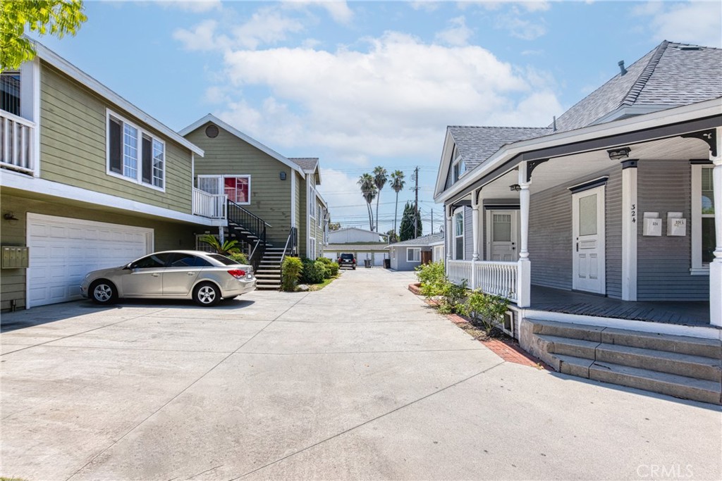 320 West Truslow Avenue, Unit D Fullerton, CA 92832 - Photo 2 of 25 a car parked in front of white building