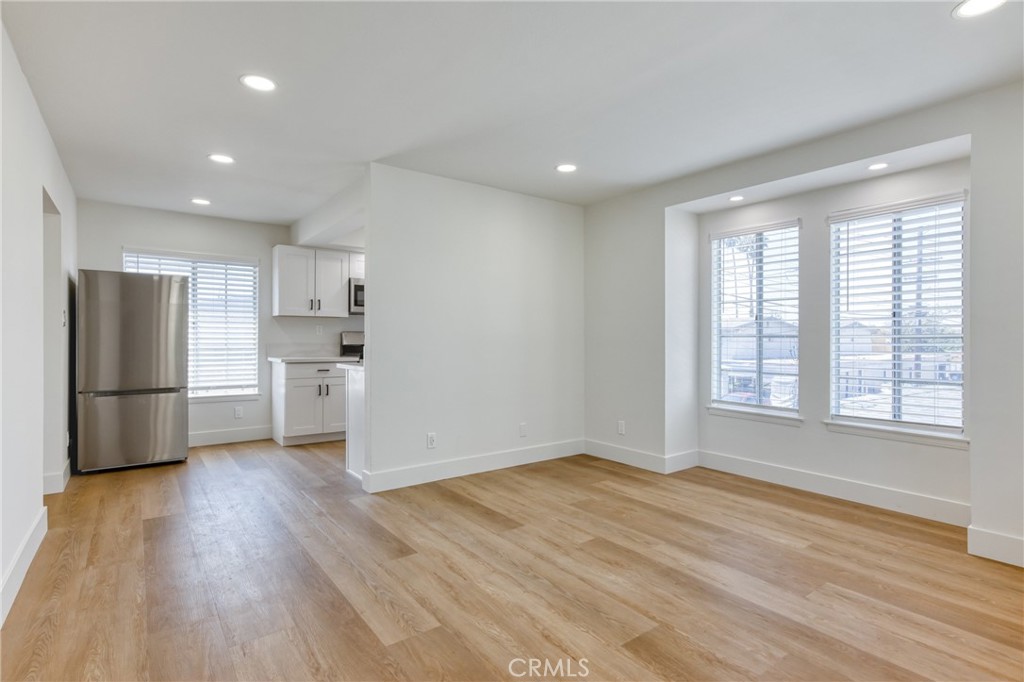 320 West Truslow Avenue, Unit D Fullerton, CA 92832 - Photo 22 of 25 a view of a kitchen with a sink refrigerator and wooden floor