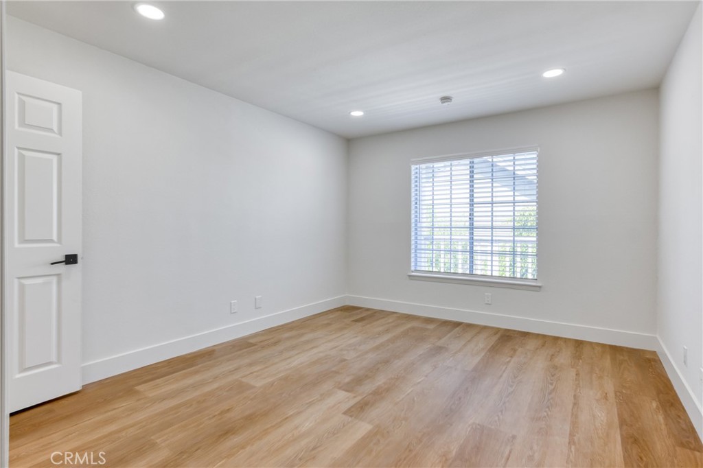 320 West Truslow Avenue, Unit D Fullerton, CA 92832 - Photo 8 of 25 a view of an empty room with wooden floor and a window