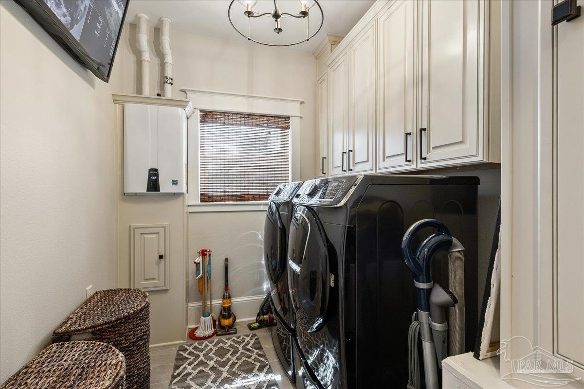 9050 Salter Road Pace, FL 32571 - Photo 15 of 48 a view of walk in closet with clothes and shoes