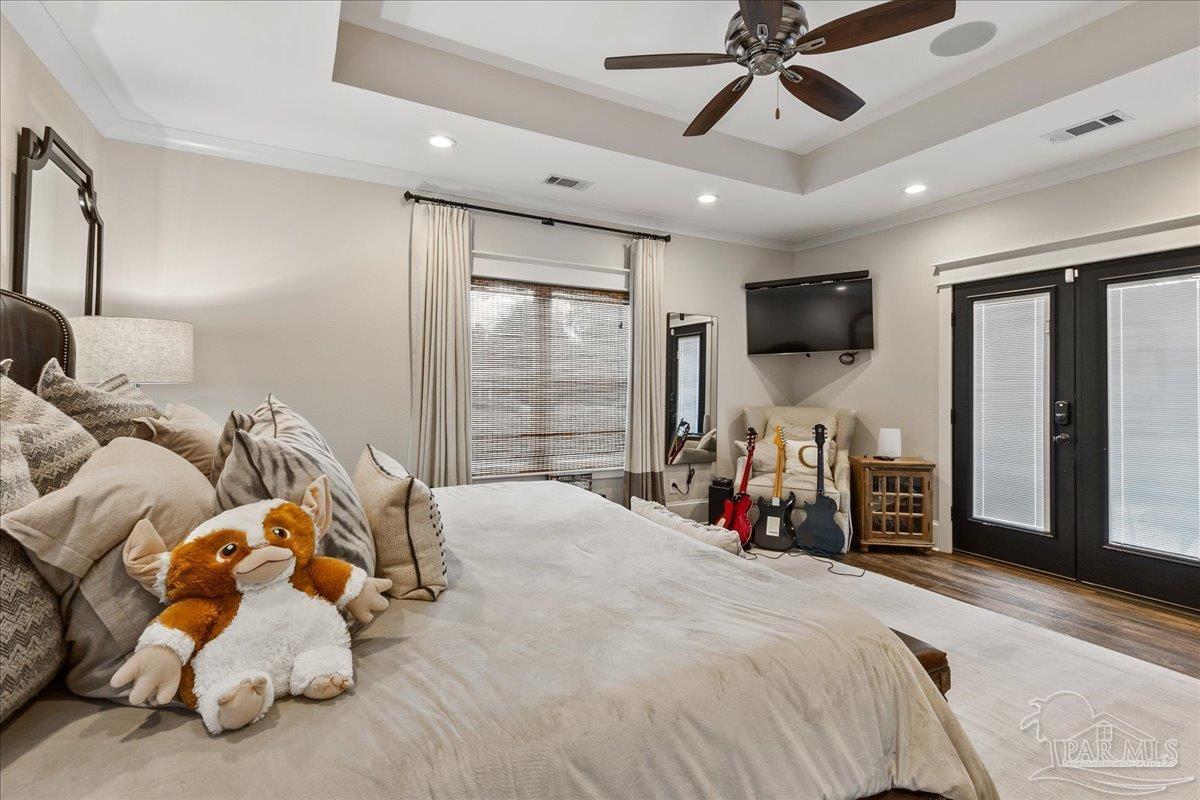9050 Salter Road Pace, FL 32571 - Photo 18 of 48 a bedroom with bed and a flat tv screen on the dresser