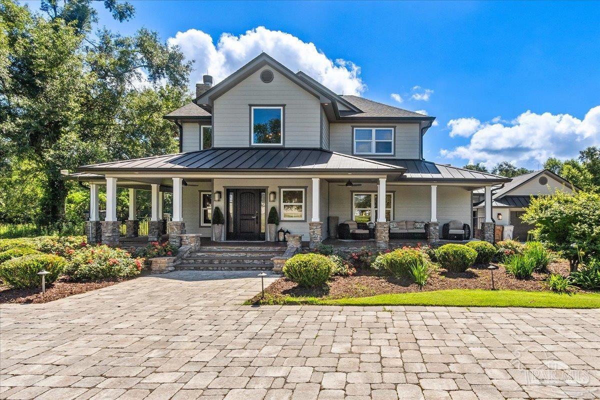 9050 Salter Road Pace, FL 32571 - Photo 2 of 48 a front view of a house with garden