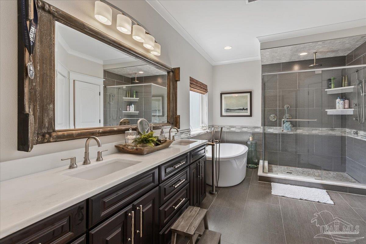 9050 Salter Road Pace, FL 32571 - Photo 21 of 48 a bathroom with a double vanity sink mirror double and bathtub