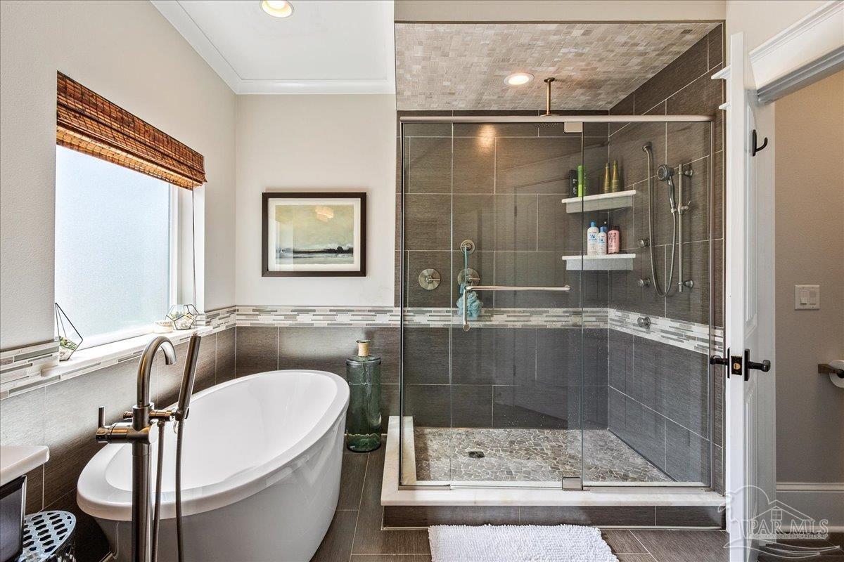 9050 Salter Road Pace, FL 32571 - Photo 22 of 48 a bathroom with a bathtub and a shower