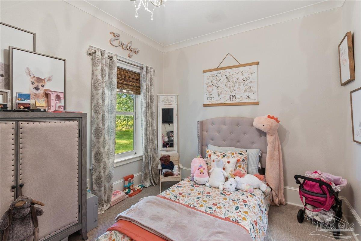 9050 Salter Road Pace, FL 32571 - Photo 24 of 48 a bedroom with a bed and a window