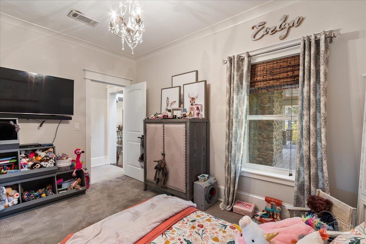 9050 Salter Road Pace, FL 32571 - Photo 25 of 48 a very nice looking bedroom with a bed and a flat screen tv