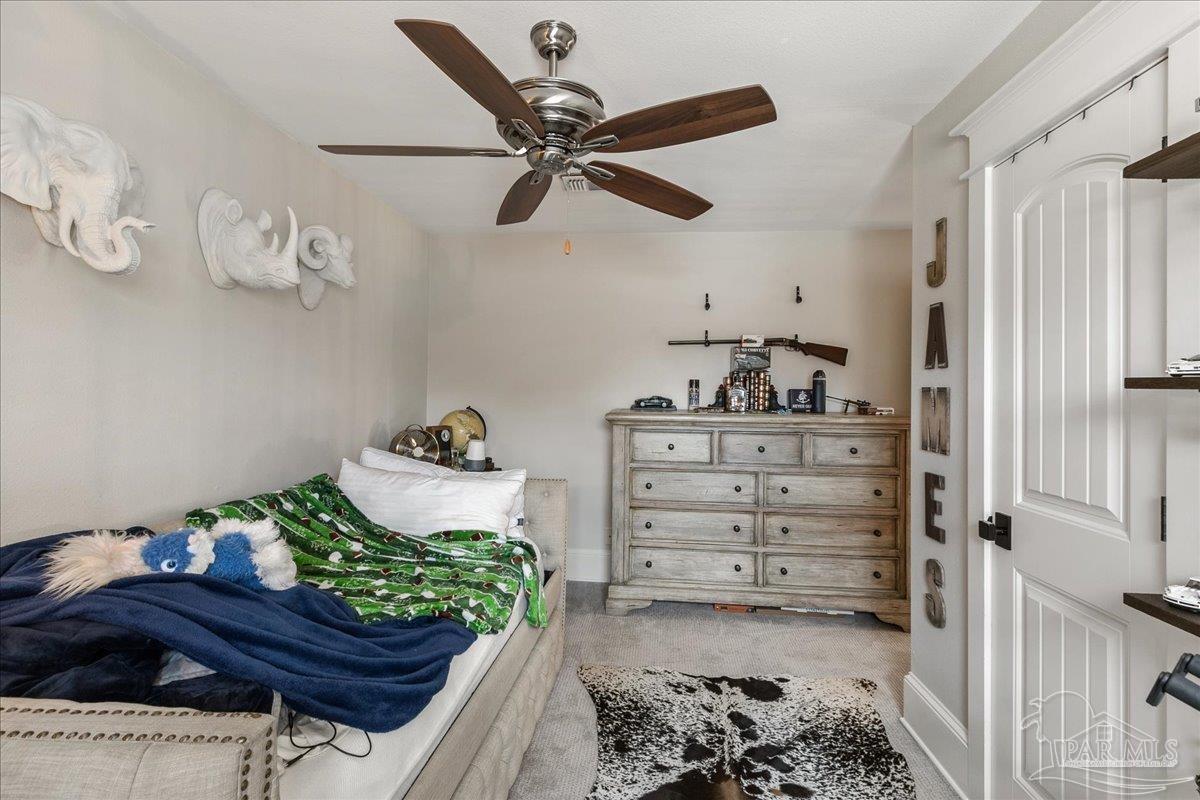 9050 Salter Road Pace, FL 32571 - Photo 31 of 48 a living room with furniture and wooden floor