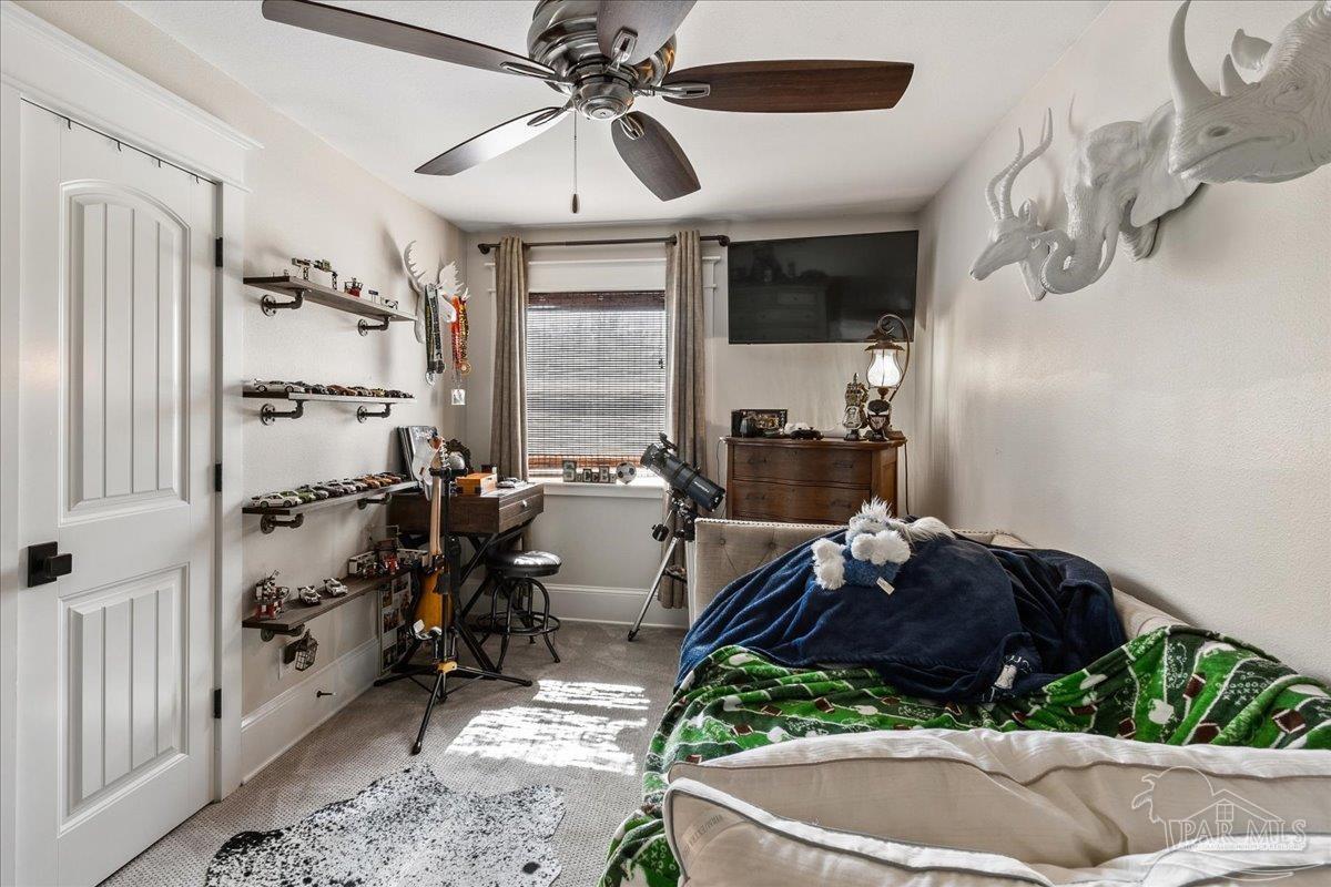 9050 Salter Road Pace, FL 32571 - Photo 32 of 48 a room with furniture a chandelier and a rug