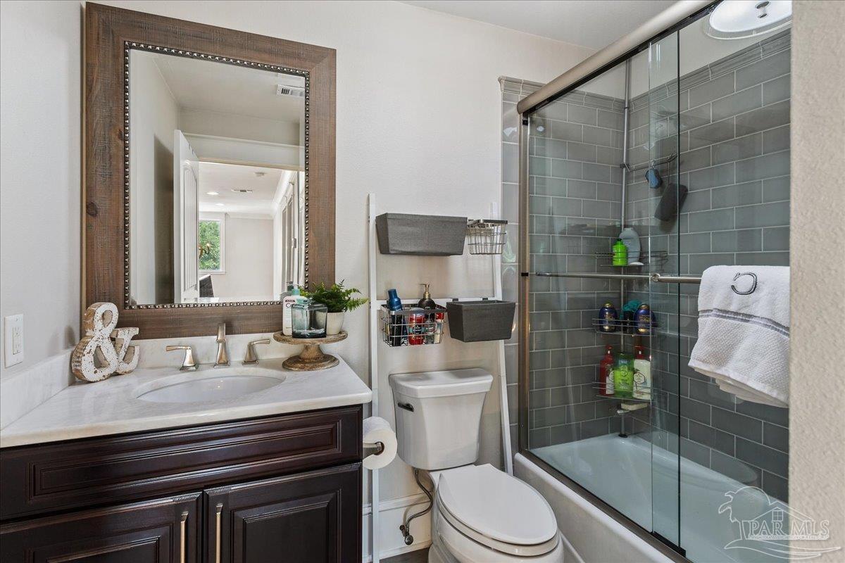 9050 Salter Road Pace, FL 32571 - Photo 33 of 48 a bathroom with a sink a toilet and shower