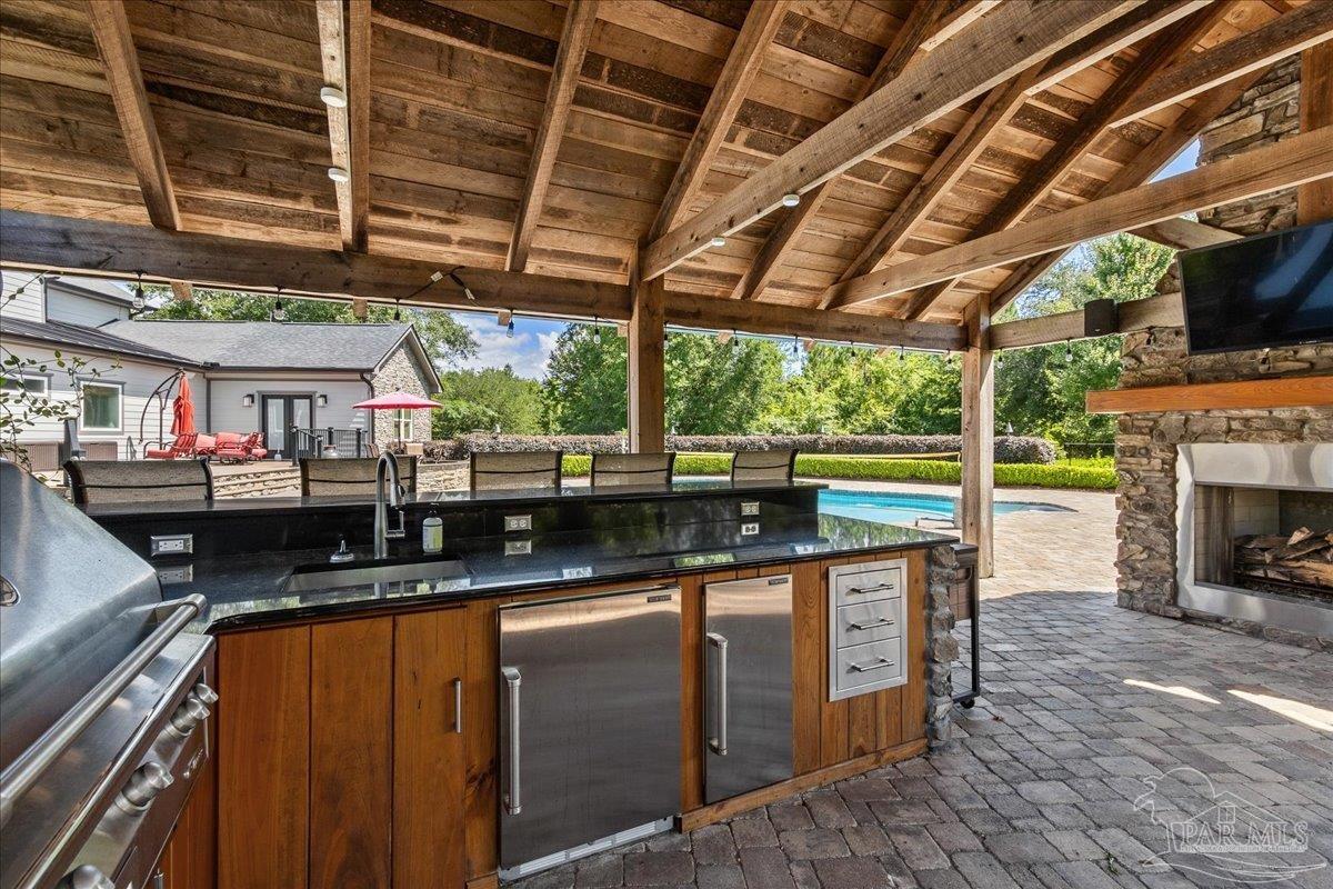 9050 Salter Road Pace, FL 32571 - Photo 38 of 48 a kitchen with stainless steel appliances granite countertop a sink and a counter top
