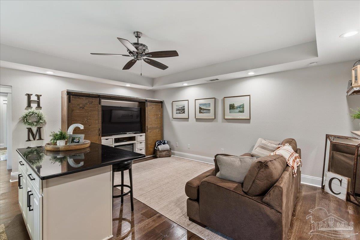 9050 Salter Road Pace, FL 32571 - Photo 40 of 48 a living room with furniture and a flat screen tv