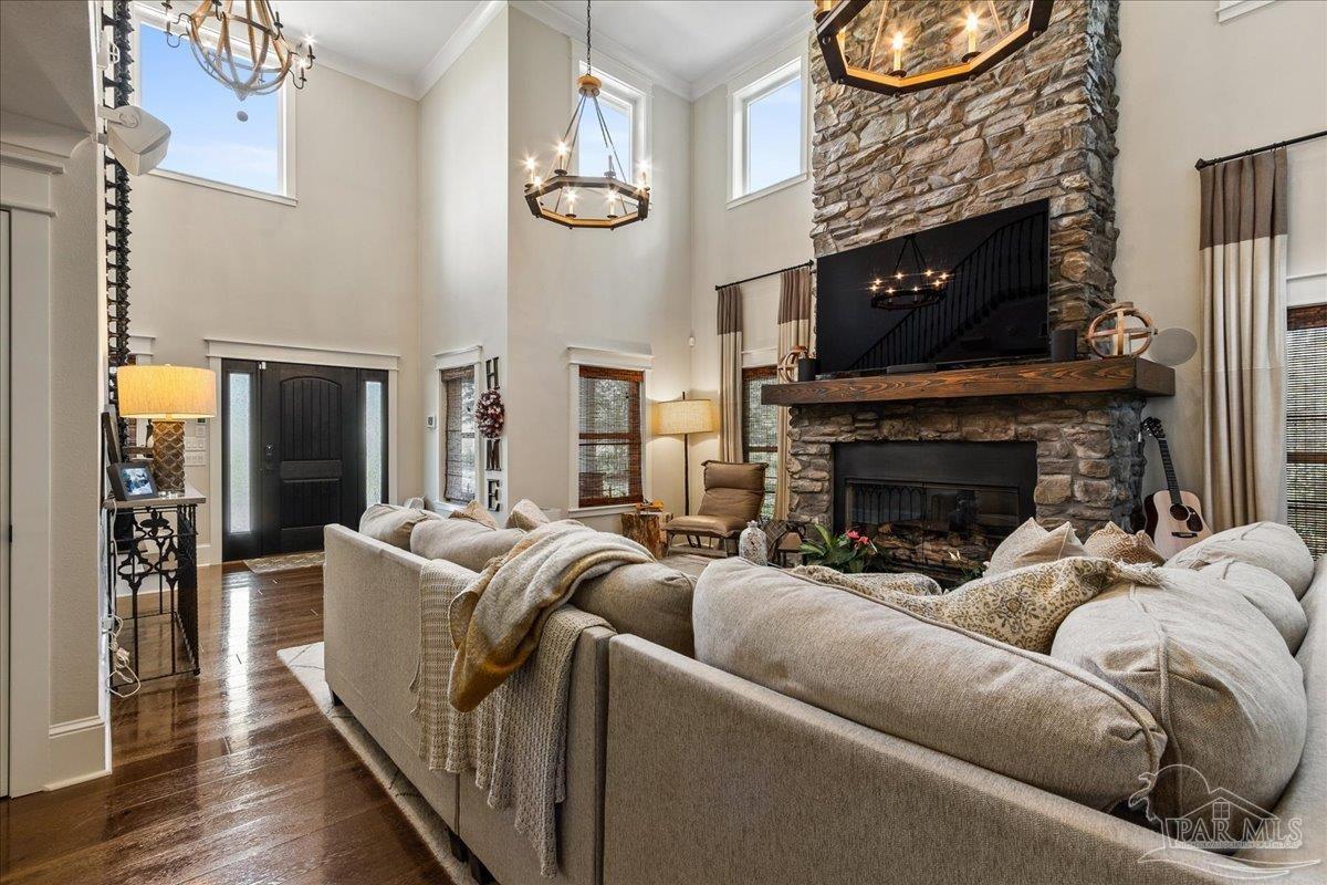 9050 Salter Road Pace, FL 32571 - Photo 4 of 48 a living room with furniture a fireplace and a floor to ceiling window