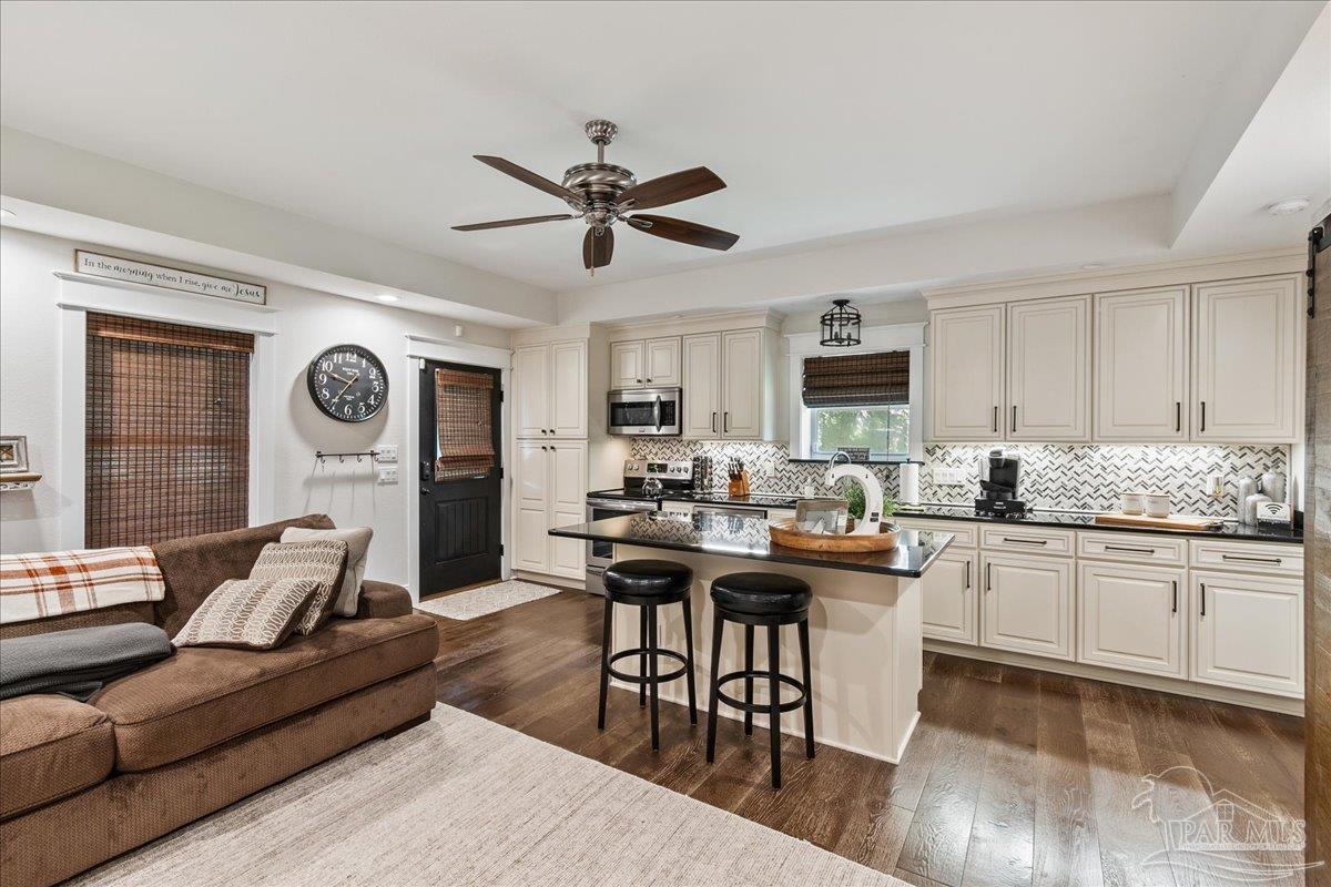 9050 Salter Road Pace, FL 32571 - Photo 42 of 48 a living room with granite countertop furniture a dining table and kitchen view