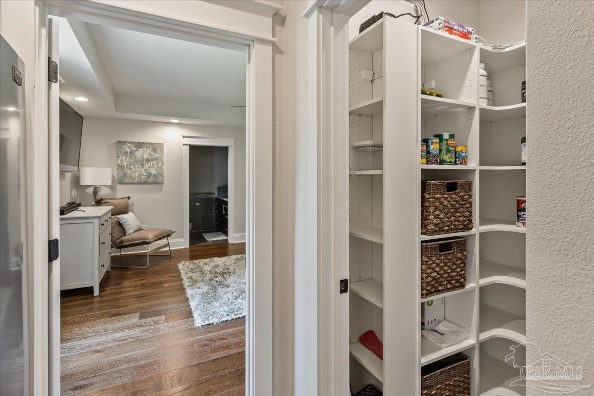 9050 Salter Road Pace, FL 32571 - Photo 43 of 48 a view of a walk in closet and bedroom with wooden floor