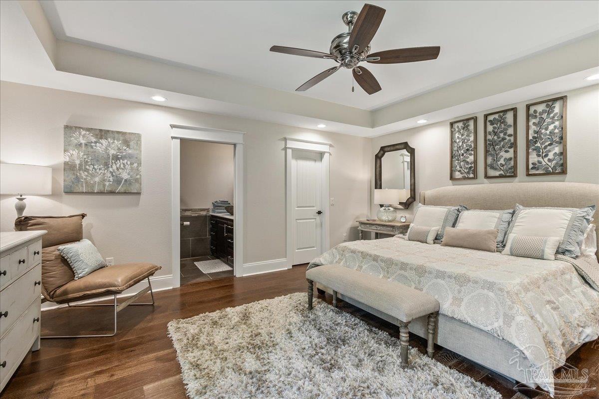 9050 Salter Road Pace, FL 32571 - Photo 44 of 48 a spacious bedroom with a bed a couch and a window