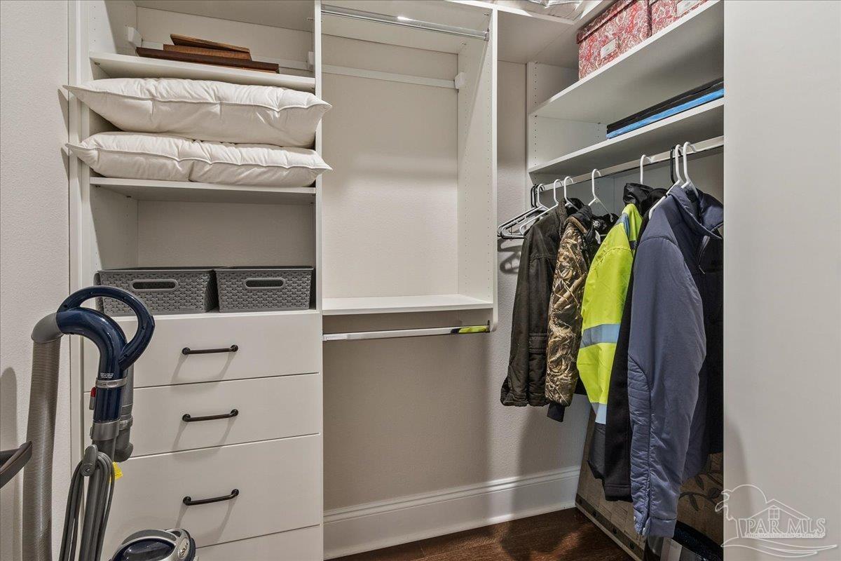 9050 Salter Road Pace, FL 32571 - Photo 46 of 48 a view of walk in closet with clothes and shoes