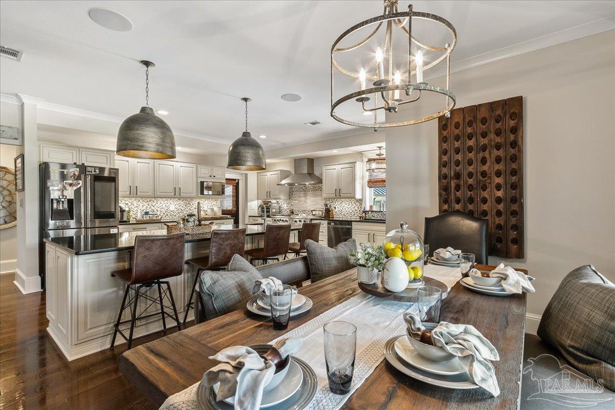 9050 Salter Road Pace, FL 32571 - Photo 10 of 48 a living room with lots of furniture and chandelier