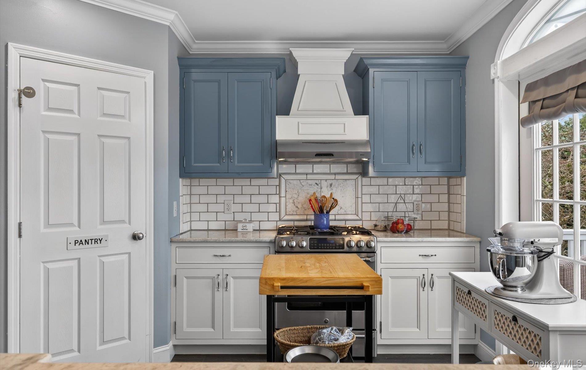 108 Awixa Avenue Bay Shore, NY 11706 - Photo 9 of 47 Kitchen with light stone counters, crown molding, tasteful backsplash, and stainless steel range with gas stovetop