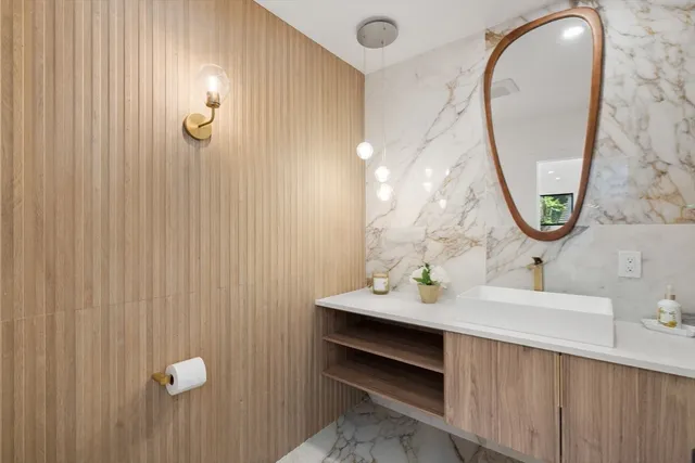 a bathroom with a sink vanity and a mirror