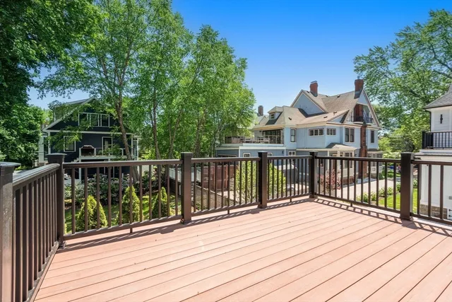 a view of a deck with wooden floor and fence and a floor to ceiling window