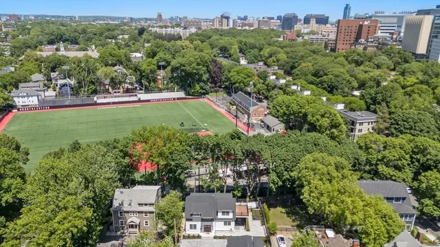 an aerial view of a house with a yard basket ball court and outdoor seating
