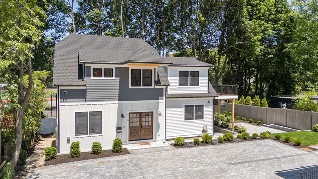 a front view of a house with a garden