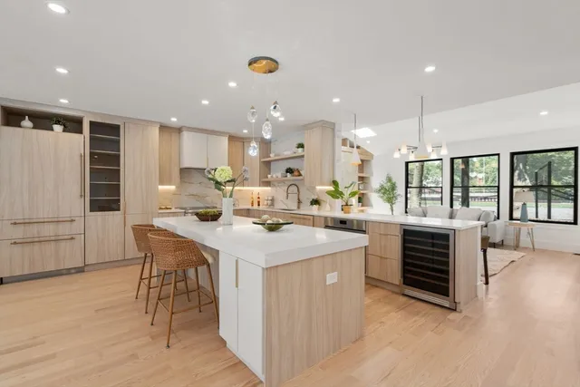a kitchen with kitchen island a sink table and chairs