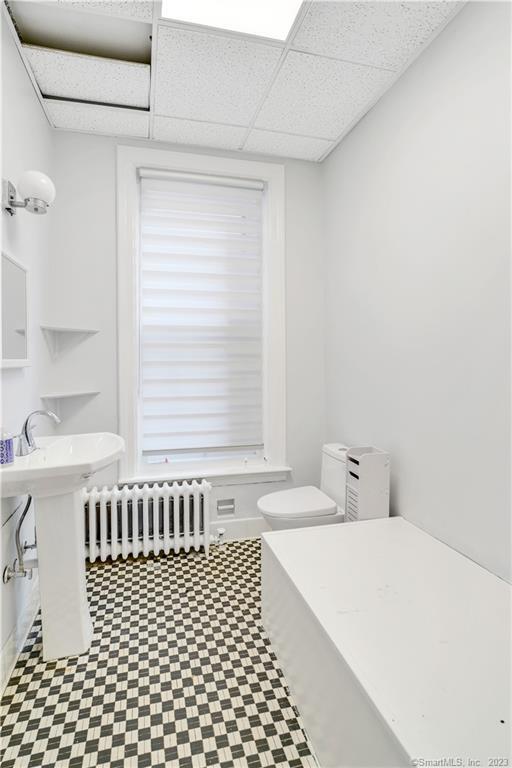 46 Washington Street Middletown, CT 06457 - Photo 2 of 8 a bathroom with a sink a toilet and a window