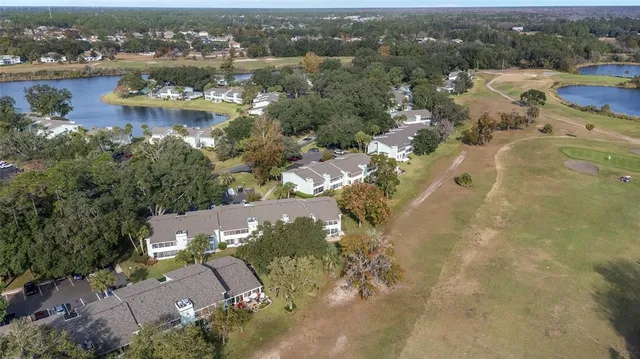 an aerial view of lake residential houses with outdoor space and swimming