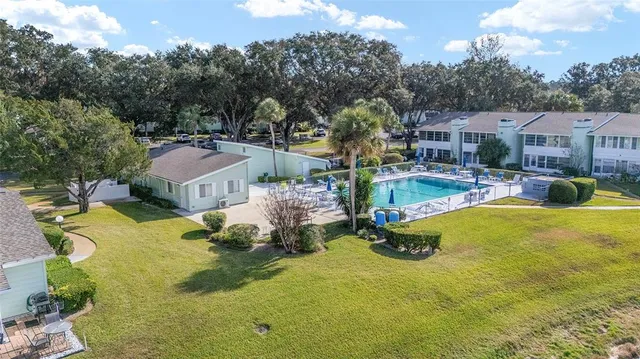 an aerial view of a house with garden space and lake view