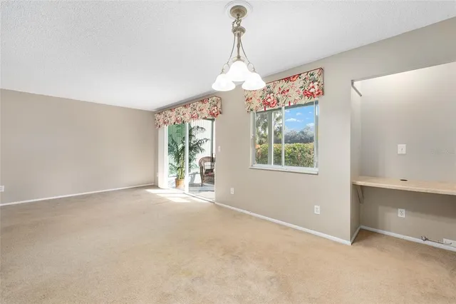 an empty room with windows and outdoor view
