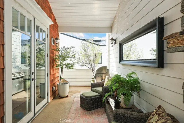 a living room filled with furniture and a potted plant