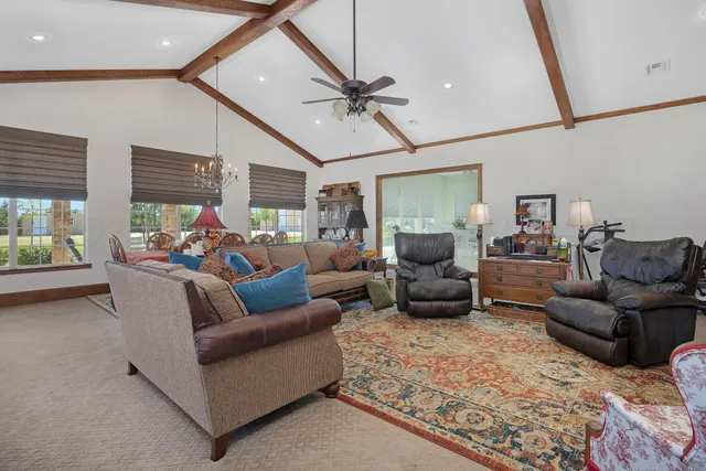 a view of a livingroom with furniture and staircase