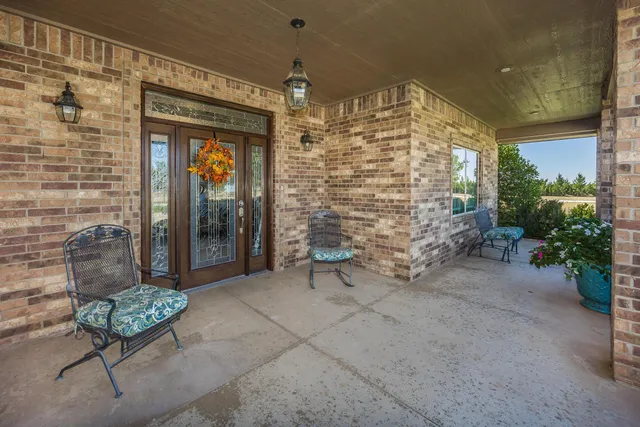 a living room with furniture large window and a fireplace