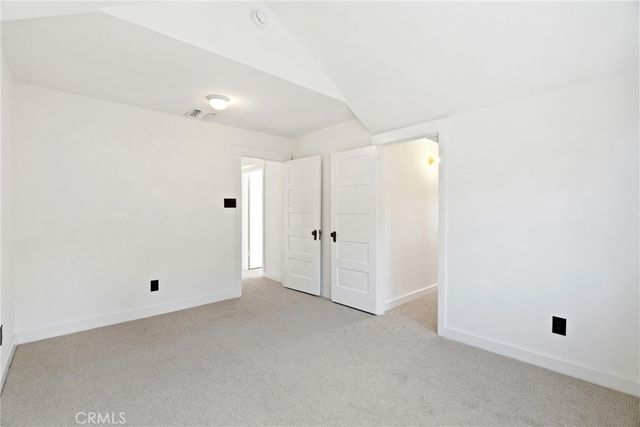 a bedroom with a bed and a lamp