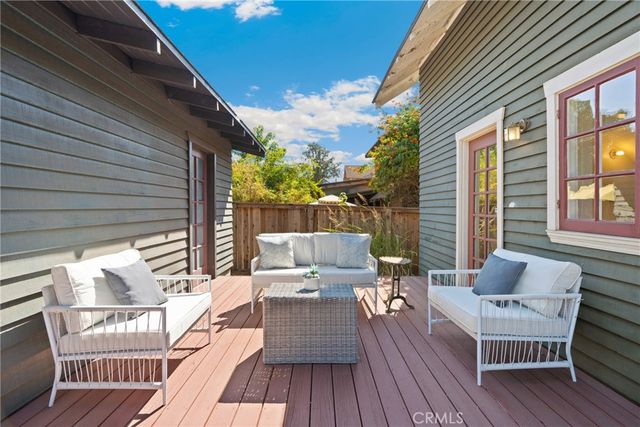 a front view of a house with a yard and potted plants