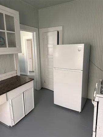 a white refrigerator freezer and a dishwasher sitting in a kitchen