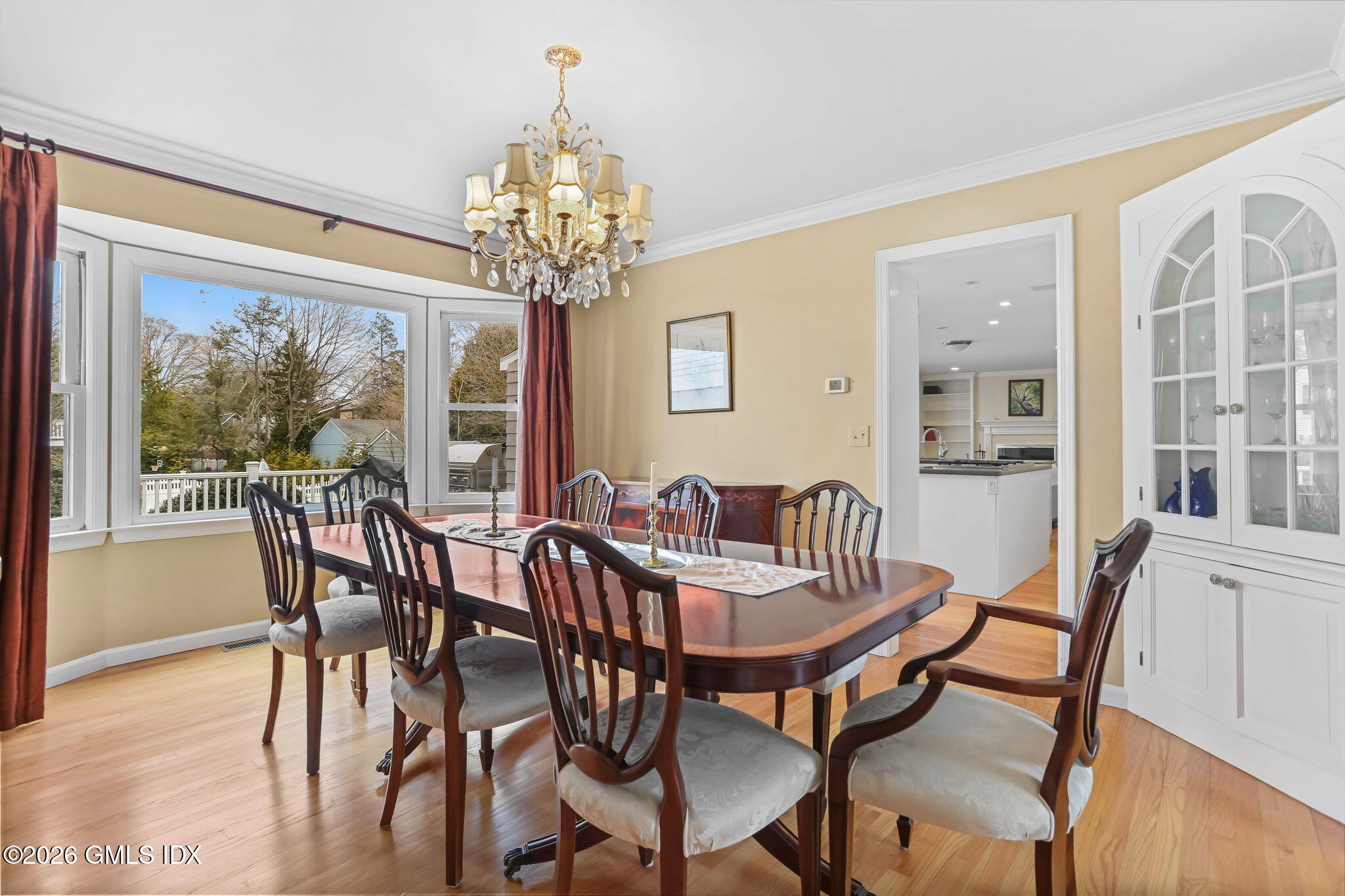 153 Lockwood Road Riverside, CT 06878 - Photo 13 of 58 a view of a dining room with furniture a chandelier and wooden floor