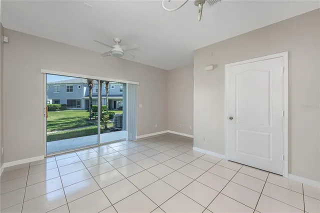 a view of an empty room with a ceiling fan