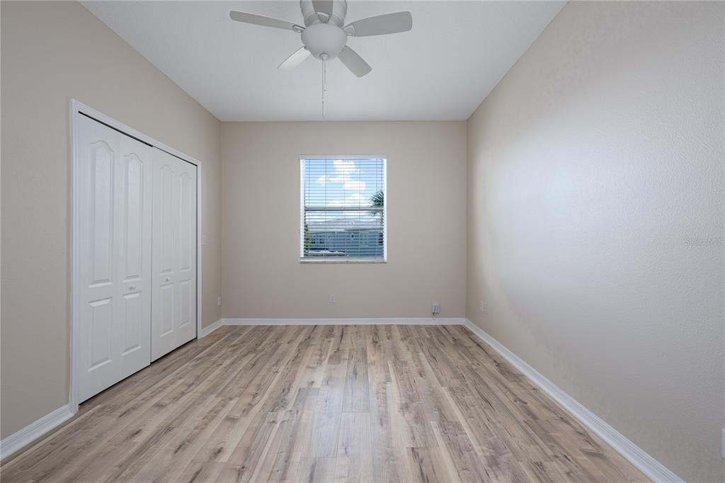 9441 Flowering Cottonwood Road, Unit 41 Orlando, FL 32832 - Photo 19 of 31 wooden floor in an empty room with a window