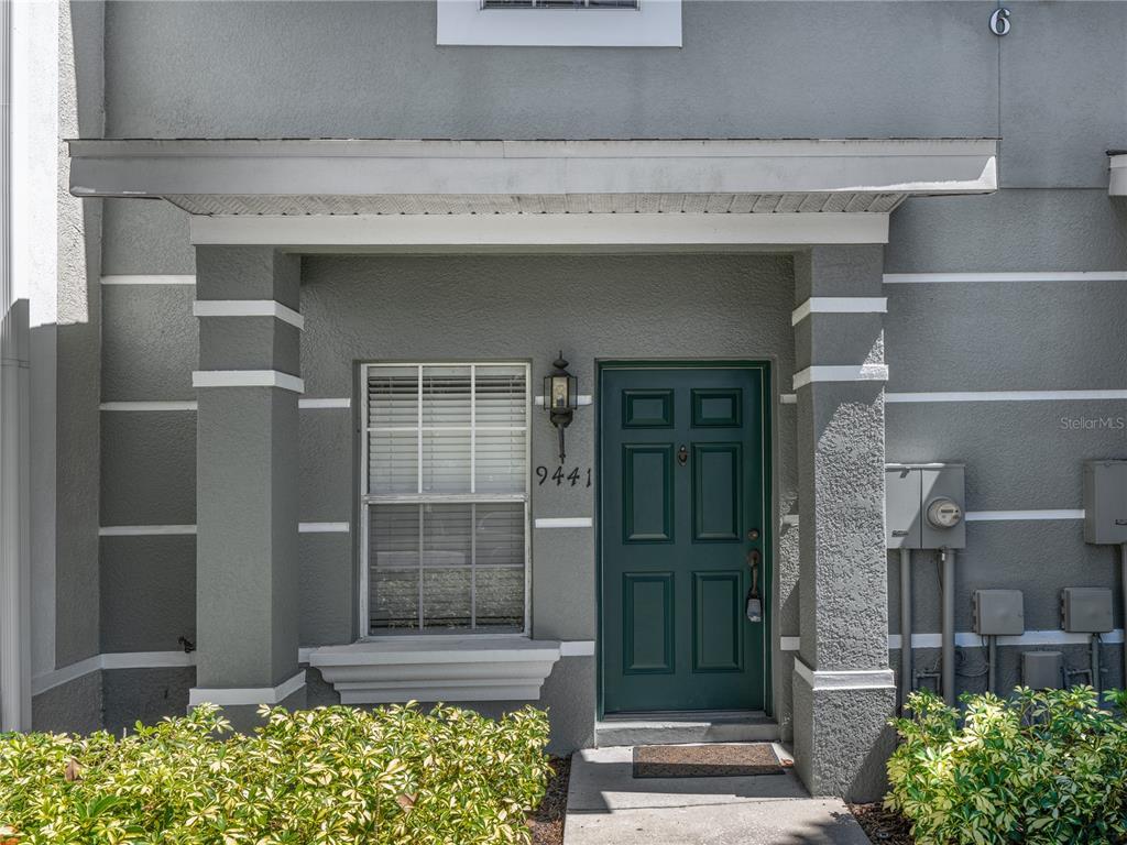 9441 Flowering Cottonwood Road, Unit 41 Orlando, FL 32832 - Photo 2 of 31 a front view of a building with a garden