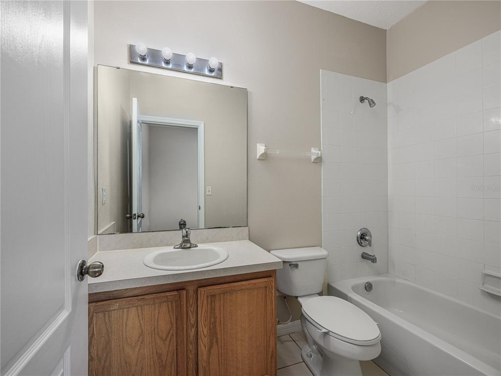 9441 Flowering Cottonwood Road, Unit 41 Orlando, FL 32832 - Photo 24 of 31 a bathroom with a sink a toilet and shower